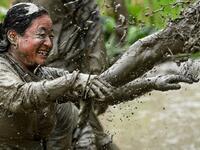 Splashing mud and drinking local rice beer, Nepali farmers this week celebrated National Paddy Day to mark the beginning of the rice-planting season, despite some coronavirus lockdown measures still in place. Traditional farming songs and laughter echoed in the air as farmers waded into waterlogged fields to sow green paddy.  PRAKASH MATHEMA / AFP