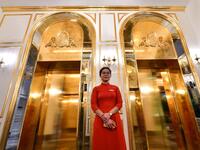 A staff member stands near the lifts in the lobby of the newly-inaugurated Dolce Hanoi Golden Lake hotel, the world's first gold-plated hotel, in Hanoi on July 2, 2020. Manan VATSYAYANA / AFP