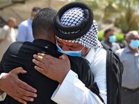 Mourners embrace during the funeral of slain Iraqi jihadism expert Hisham al-Hashemi, who was shot dead yesterday outside his house in the Iraqi capital, in Baghdad’s Zayouna district on July 7, 2020. Hashemi was an authoritative voice on Sunni jihadist factions including the Islamic State group, but was also frequently consulted by media and foreign governments on domestic Iraqi politics and Shiite armed groups. He had warm ties with top decision-makers, including President Barham Saleh.