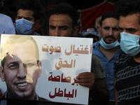Iraqi demonstrators attend a symbolic funeral for slain Iraqi jihadism expert Hisham al-Hashemi, who was shot dead yesterday outside his house in the Iraqi capital, on July 7, 2020 at Baghdad's Tahrir square. Slogan reads in Arabic: "the voice of right killed with the bullet of wrong". The killing of the 47-year-old prominent expert has stirred fears Iraq is entering a dark and violent phase, as boiling tensions between pro-Iran factions and the government reach new heights. AHMAD AL-RUBAYE / AFP