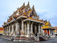 This photograph taken on July 14, 2020 shows the Wat Pariwat Buddhist temple in Bangkok. Wat Pariwat, also known as "the David Beckham Temple", is decorated with statues of superheroes and comic characters as well as mythical and imaginary creatures. A golden-plated sculpture of the English football player holding the base of a Buddha statue in one of the buildings gives the temple its nickname. Mladen ANTONOV / AFP