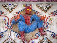 This photograph taken on July 14, 2020 shows a figure of Spiderman on the facade of the Wat Pariwat Buddhist temple in Bangkok. Wat Pariwat, also known as "the David Beckham Temple", is decorated with statues of superheroes and comic characters as well as mythical and imaginary creatures. A golden-plated sculpture of the English football player holding the base of a Buddha statue in one of the buildings gives the temple its nickname. Mladen ANTONOV / AFP