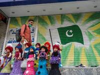 A man walks past a shuttered market in Rawalpindi on July 29, 2020, after the Punjab province government announced a lockdown closing markets, shopping malls and plazas to contain the spread of the COVID-19 coronavirus on the occasion of the Muslim festival Eid al-Adha or the 'Festival of Sacrifice'. Farooq NAEEM / AFP
