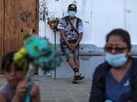 Catholic faithfuls wear face masks as a preventive measure against the spread of the novel coronavirus, COVID-19, during the opening of the ten-day celebration of the Santo Domingo de Guzman festival, outside the Las Sierritas de Santo Domingo church in Managua, on August 1, 2020. Despite the Catholic Church cancelling all religious activities due to the coronavirus pandemic, devotees gathered outside the church for the celebration. Inti OCON / AFP