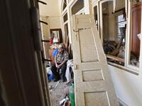 A man sits inside his damaged house in the Lebanese capital Beirut on August 6, 2020, two days after a massive explosion shook the Lebanese capital. The blast, which appeared to have been caused by a fire igniting 2,750 tonnes of ammonium nitrate left unsecured in a warehouse, was felt as far away as Cyprus, some 150 miles (240 kilometres) to the northwest. The scale of the destruction was such that the Lebanese capital resembled the scene of an earthquake, with thousands of people left homeless and thousan