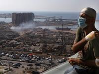 Lebanese TV producer Tony Ahwaji sits injured on the balcony of his damaged apartment in the damaged neighbourhood of Mar Mikhael in the Lebanese capital Beirut on August 6, 2020, two days after a massive explosion shook the Lebanese capital. The blast, which appeared to have been caused by a fire igniting 2,750 tonnes of ammonium nitrate left unsecured in a warehouse, was felt as far away as Cyprus, some 150 miles (240 kilometres) to the northwest. The scale of the destruction was such that the Lebanese ca
