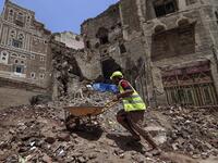 Yemeni labourers remove the rubble ahead of restoration works on the site of a collapsed UNESCO-listed building following heavy rains, in the old city of the Yemeni capital Sanaa, on August 12, 2020. Flash floods triggered by torrential rains have killed at least 172 people across Yemen over the past month, damaging homes and UNESCO-listed world heritage sites, officials said. Mohammed HUWAIS / AFP