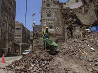A Yemeni labourer removes the rubble ahead of restoration works on the site of a collapsed UNESCO-listed building following heavy rains, in the old city of the Yemeni capital Sanaa, on August 12, 2020. Flash floods triggered by torrential rains have killed at least 172 people across Yemen over the past month, damaging homes and UNESCO-listed world heritage sites, officials said. Mohammed HUWAIS / AFP