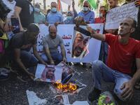 Palestinian protesters burn pictures of Abu Dhabi Crown Prince Sheikh Mohammed bin Zayed Al Nahyan (top) and Saudi Crown Prince Mohammed bin Salman, during a demonstration against the Emirati-Israeli agreement, in Ramallah in the occupied West Bank, on August 15, 2020. ABBAS MOMANI / AFP