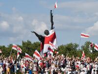 Belarus opposition supporters hold former white-red-white flags of Belarus used in opposition to the government, during a demonstration in central Minsk on August 16, 2020. The Belarusian strongman, who has ruled his ex-Soviet country with an iron grip since 1994, is under increasing pressure from the streets and abroad over his claim to have won re-election on August 9, with 80 percent of the vote. Sergei GAPON / AFP