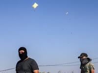 Inflated plastic bags carrying incendiary devices float in the air upon being released by Palestinians and flown towards Israel, near Rafah along the border between the Gaza Strip and Israel on August 21, 2020. SAID KHATIB / AFP
