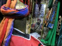 An Ashura re-enactor is assisted to get into costume before playing out a procession commemorating the entry of Imam Hussein and his family and retinue into Karbala, as Shiite Muslims mark the Ashura period in Iraq's central holy shrine city on August 22, 2020. Ashura is a period of mourning in remembrance of the seventh-century martyrdom of Prophet Mohammad's grandson Imam Hussein, who was killed in the battle of Karbala in modern-day Iraq, in 680 AD. Mohammed SAWAF / AFP