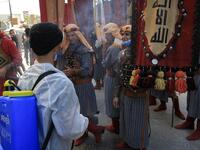 Ashura re-enactors in costume are doused, as a COVID-19 coronavirus pandemic precaution, while playing out a procession commemorating the entry of Imam Hussein and his family and retinue into Karbala, as Shiite Muslims mark the Ashura period in Iraq's central holy shrine city on August 22, 2020. Ashura is a period of mourning in remembrance of the seventh-century martyrdom of Prophet Mohammad's grandson Imam Hussein, who was killed in the battle of Karbala in modern-day Iraq, in 680 AD. Mohammed SAWAF / AFP