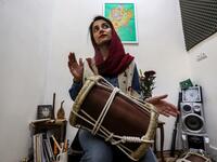 Negin Heydari, a former member of the all-women Iranian music band "Dingo" who plays the kasser drum, poses for a picture as she practises at a home studio called the "Dingo room" in Iran's southern Gulf port city of Bandar Abbas on April 30, 2019. ATTA KENARE / AFP