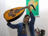 Noushin Yousefzadeh, a member of the all-women Iranian music band "Dingo" who plays the Oud (Middle Eastern lute), poses for a picture as she practises at a home studio called the "Dingo room" in Iran's southern Gulf port city of Bandar Abbas on April 30, 2019. ATTA KENARE / AFP