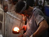 A glassblower forms glass at factory, which is recycling the broken glass as a result of the Beirut explosion, in the northern Lebanese port city of Tripoli on August 25, 2020. The August 4 port explosion ripped through countless glass doors and windows when it laid waste to whole Beirut neighbourhoods, killing at least 190 people and wounding thousands more. Volunteers, non-governmental groups and entrepreneurs salvaged a fraction of the tonnes of broken glass that littered the streets, some of it through 