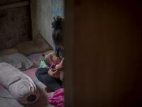 This picture taken on February 9, 2019 shows Nurlina, 19, who got married in 2017, breastfeeding her daughter in the village of Galung Lombok in West Sulawesi. Child marriage has long been common in traditional communities from the Indonesian archipelago to India, Pakistan and Vietnam, but numbers had been decreasing as charities made inroads by encouraging access to education and women's health services. YUSUF WAHIL / AFP