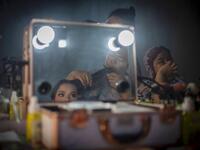 This picture taken on July 25, 2020 shows 18-year-old Lia (L, not her real name), wearing make-up and having her hair done, at her relative's house before getting married with 21-year-old Randi (not pictured) in the village of Tampapadang in Mamuju, West Sulawesi. Child marriage has long been common in traditional communities from the Indonesian archipelago to India, Pakistan and Vietnam, but numbers had been decreasing as charities made inroads by encouraging access to education and women's health services