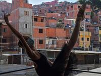 Mariana Sousa, student of the Ballet Paraisopolis, warms up during a rehearse in Paraisopolis favela, outskirts of Sao Paulo, Brazil on August 27, 2020, amid the new coronavirus COVID-19 pandemic. NELSON ALMEIDA / AFP