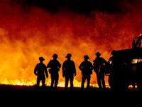 Butte County firefighters watch as flames quickly spread across a road at the Bear fire in Oroville, California on September 9, 2020. Dangerous dry winds whipped up California's record-breaking wildfires and ignited new blazes, as hundreds were evacuated by helicopter and tens of thousands were plunged into darkness by power outages across the western United States. JOSH EDELSON / AFP