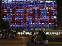 The windows of the Tel Aviv-Yafo Municipality building illuminated with the word "Peace" in English on September 15, 2020 to celebrate the signing of the landmark Israeli normalisation deals with the United Arab Emirates and Bahrain. Israeli Prime Minister Benjamin Netanyahu signed landmark accords normalizing the Jewish state's relations with the United Arab Emirates and Bahrain, as part of a peace push brokered by US President Donald Trump.  JACK GUEZ / AFP