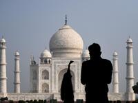 Tourists take pictures as the visit the Taj Mahal in Agra on September 21, 2020. The Taj Mahal reopened to visitors on September 21 in a symbolic business-as-usual gesture even as India looks set to overtake the US as the global leader in coronavirus infections. Sajjad HUSSAIN / AFP