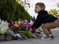 A young boy places flowers at a makeshift memorial in honor of Supreme Court Justice Ruth Bader Ginsburg in front of the US Supreme Court on September 19, 2020 in Washington, DC. Justice Ginsburg has died at age 87 after a battle with pancreatic cancer. Samuel Corum/Getty Images/AFP Samuel Corum / GETTY IMAGES NORTH AMERICA / Getty Images via AFP