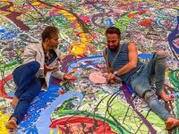 British artist Sacha Jafri paces barefoot back and forth across his giant canvas stretched across the ballroom floor of a luxury Dubai hotel, listening to a young girl singing. (Instagram)