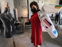 Dr. Fulvia Vergara wears her white coat decorated by Panamanian artist Genaro Rodriguez in Panama City, on September 26, 2020. More than 20 doctor's coats fighting against COVID-19 that were disinfected and painted by Panamanian artists will be auctioned off from October 1 to 4. The funds will go to 20 health centers. Luis ACOSTA / AFP