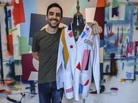 Panamanian artist Genaro Rodriguez poses with the white coat used by Dr. Fulvia Vergara and decorated by him in Panama City, on September 25, 2020. More than 20 doctor's coats fighting against COVID-19 that were disinfected and painted by Panamanian artists will be auctioned off from October 1 to 4. The funds will go to 20 health centers. Luis ACOSTA / AFP
