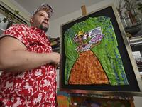 Panamanian artist Rolando de Sedas poses with the white coat used by Dr. Lilian Valdez and and decorated by him in Panama City, on September 25, 2020. More than 20 doctor's coats fighting against COVID-19 that were disinfected and painted by Panamanian artists will be auctioned off from October 1 to 4. The funds will go to 20 health centers. Luis ACOSTA / AFP