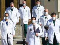 White House physician Sean Conley (C) arrives to answer questions surrounded by other doctors, during an update on the condition of US President Donald Trump, on October 5, 2020, at Walter Reed Medical Center in Bethesda, Maryland. President Donald Trump announced that he is leaving the hospital where he was given emergency treatment for Covid-19 and told the nation, where the virus has killed almost 210,000 people this year, that they have nothing to worry about. SAUL LOEB / AFP