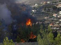 A picture taken near the northern Israeli kibbutz of Misgav Am in the Upper Galilee, shows a fire burning on the Lebanese side of the border with Israel on October 9, 2020. Several fires spread across northern and central Israel and the occupied West Bank as temperatures soared, forcing the evacuation of thousands of people, authorities said.  JALAA MAREY / AFP