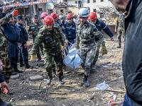 Rescuers carry away the body of a victim at the blast site hit by a rocket during the fighting between Armenia and Azerbaijan over the breakaway region of Nagorno-Karabakh, in the city of Ganja, Azerbaijan, on October 11, 2020. Bulent Kilic / AFP