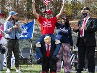 People dressed in political costumes participate in a contest during a Trump campaign rally named "Trumptoberfest" at Rocky Point Park in Warwick, Rhode Island on October 11, 2020. Many supporters dressed in political campaign clothing and waved flags while others dressed in festive costumes to take part in a political costume contest. Joseph Prezioso / AFP
