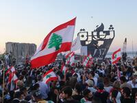 Lebanese protesters gather to light the "October 17 torch" marking the one year anniversary of the beginning of a nationwide anti-government protest movement, in front of the devastated port of the capital Beirut where a massive explosion took place more than two months ago, on October 17, 2020. ANWAR AMRO / AFP