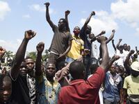 Protesters chant and sing solidarity songs as they barricade barricade the Lagos-Ibadan expressway to protest against police brutality and the killing of protesters by the military, at Magboro, Ogun State, on October 21, 2020. Buildings in Nigeria's main city of Lagos were torched on October 21, 2020 and sporadic clashes erupted after the shooting of peaceful protesters in which Amnesty International said security forces had killed several people. Witnesses said gunmen opened fire on a crowd of over 1,000 p