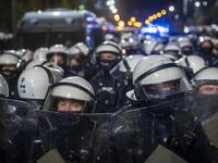 Riot police guarding the house of Jaroslaw Kaczynski, leader of Poland's ruling Law and Justice party (PIS) watch protestors during a demonstration against a decision by the Constitutional Court on abortion law restriction,in Warsaw on October 23, 2020. Wojtek RADWANSKI / AFP