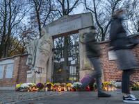 Candles and flowers lay in front of the locked gate to Powazki cementary in Warsaw, Poland, on November 1, 2020, while the polish government closed cemeteries due to COVID-19 restrictions two days before the All Saints' Day, preventing Poles from visiting their loved ones graves according to tradition. The Polish government announced on October 30, 2020 the closure of cemeteries for three days, around All Saints' Day, to curb the outbreak of new contaminations in the country. Wojtek RADWANSKI / AFP