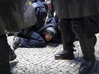 Police officers hold down a protestor as they clash with police during the rally against government’s coronavirus restrictions in Ljubljana on November 5, 2020. Jure Makovec / AFP