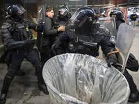 Police officers wearing riot gear grab a protester as they clash with police during the rally against government’s coronavirus restrictions in Ljubljana on November 5, 2020. Jure Makovec / AFP
