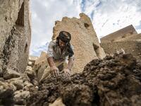 An Egyptian labouror works on the restoration of the fortress of Shali, in the Egyptian desert oasis of Siwa, some 600 kms southwest of the capital Cairo, on November 5, 2020. The 13th century edifice, called Shali or "Home" in the Siwi language, was built by Berber populations, using kershef, a mixture of clay, salt and rock which acts as a natural insulator in an area where the summer heat can be scorching. Khaled DESOUKI / AFP