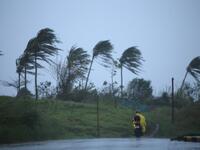 A motorist passes along a street amidst strong winds in Legazpi City, Albay province on November 11, 2020, ahead of the landfall of Tropical Storm Vamco -- expected to intensify into a typhoon -- in the region devastated by two typhoons in less than three weeks. Charism SAYAT / AFP