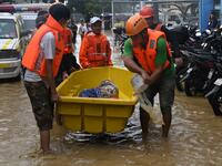 Rescuers evacuate an elderly resident from her flooded home after Typhoon Vamco hit, in Marikina City, suburban Manila on November 12, 2020. Ted ALJIBE / AFP