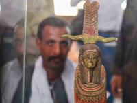 A picture shows a statue on display during the unveiling of an ancient treasure trove of more than a 100 intact sarcophagi, at the Saqqara necropolis 30 kms south of the Egyptian capital Cairo, on November 14, 2020. Egypt announced the discovery of an ancient treasure trove of more than a 100 intact sarcophagi, the largest such find this year. The sealed wooden coffins, unveiled on site amid fanfare, belonged to top officials of the Late Period and the Ptolemaic period of ancient Egypt. They were found in t