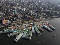 In this aerial photograph taken on November 16, 2020 passenger ferry ships are seen moored on the Buriganga River in Dhaka. Rivers are the lifeblood of the delta nation of 168 million people where much of the low-lying land is accessed via boat, with Bangladesh's strong economic growth of recent years fuelling more investments in new and bigger ships. Munir UZ ZAMAN / AFP