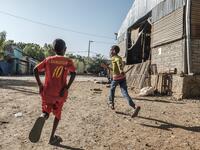 Children play next to the market in Humera, Ethiopia, on November 22, 2020. Prime Minister Abiy Ahmed, last year's Nobel Peace Prize winner, announced military operations in Tigray on November 4, 2020, saying they came in response to attacks on federal army camps by the party, the Tigray People's Liberation Front (TPLF). EDUARDO SOTERAS / AFP