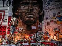 Flowers, posters and other items are left at a makeshift shrine outside the stadium named after Maradona in Buenos Aires. AFP/File