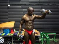 A bodybuilder warms up backstage before competing in the Iron Fit Bodybuilding competition in Nairobi on December 05, 2020. 130 participants from all across East Africa took part in the second edition of this competition which included categories like Bikini, Figure, Physique and Bodybuilding. Patrick Meinhardt / AFP