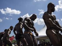 Bodybuilders pose on stage during the Iron Fit Bodybuilding competition in Nairobi on December 05, 2020. 130 participants from all across East Africa took part in the second edition of this competition which included categories like Bikini, Figure, Physique and Bodybuilding. Patrick Meinhardt / AFP